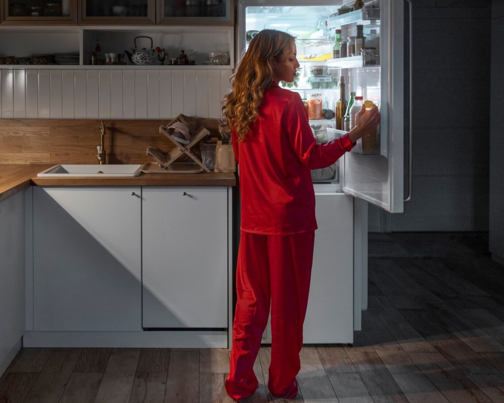 full shot woman checking fridge night 23 2150301869